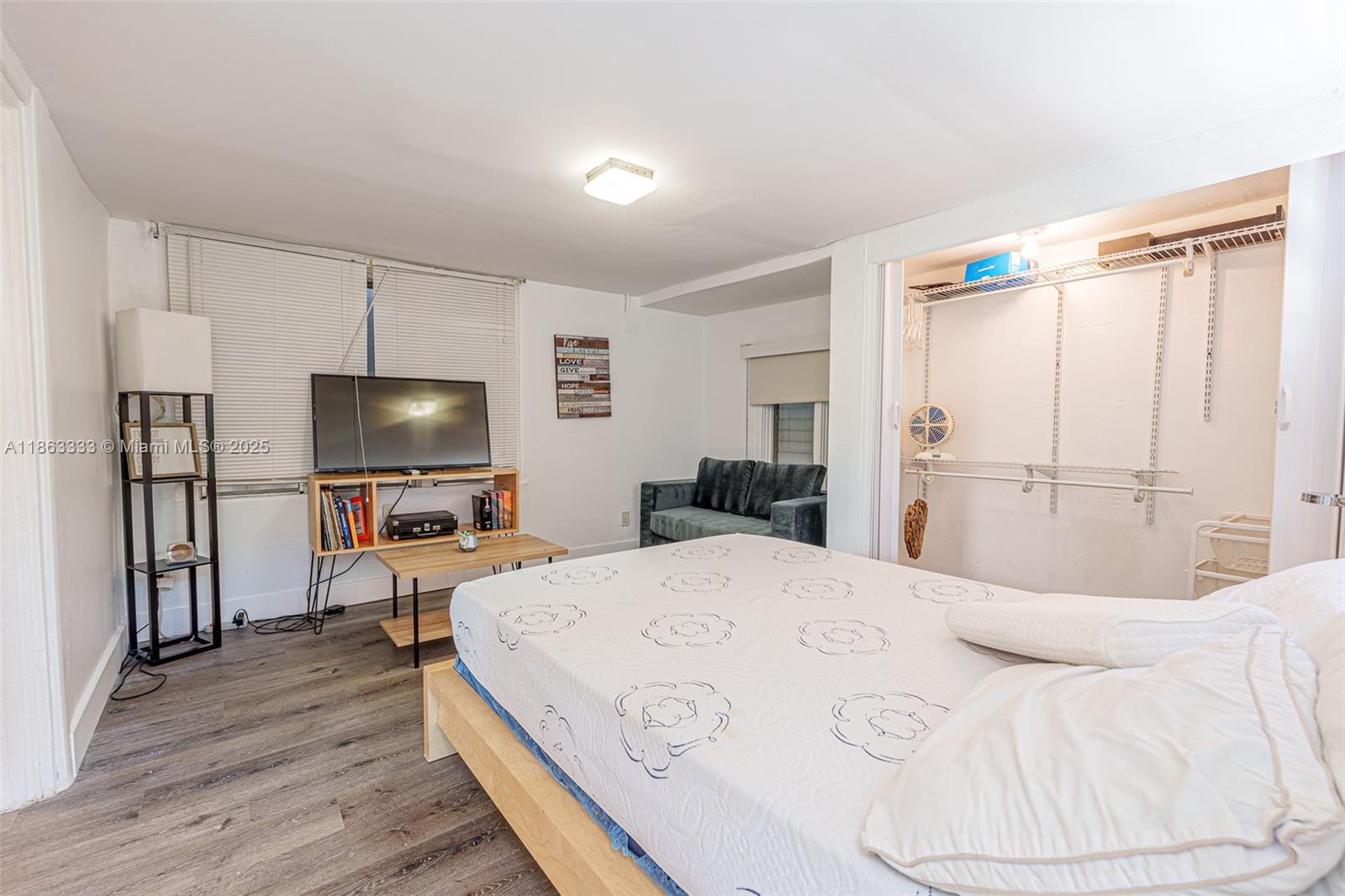 a bedroom with a bed and a flat screen tv