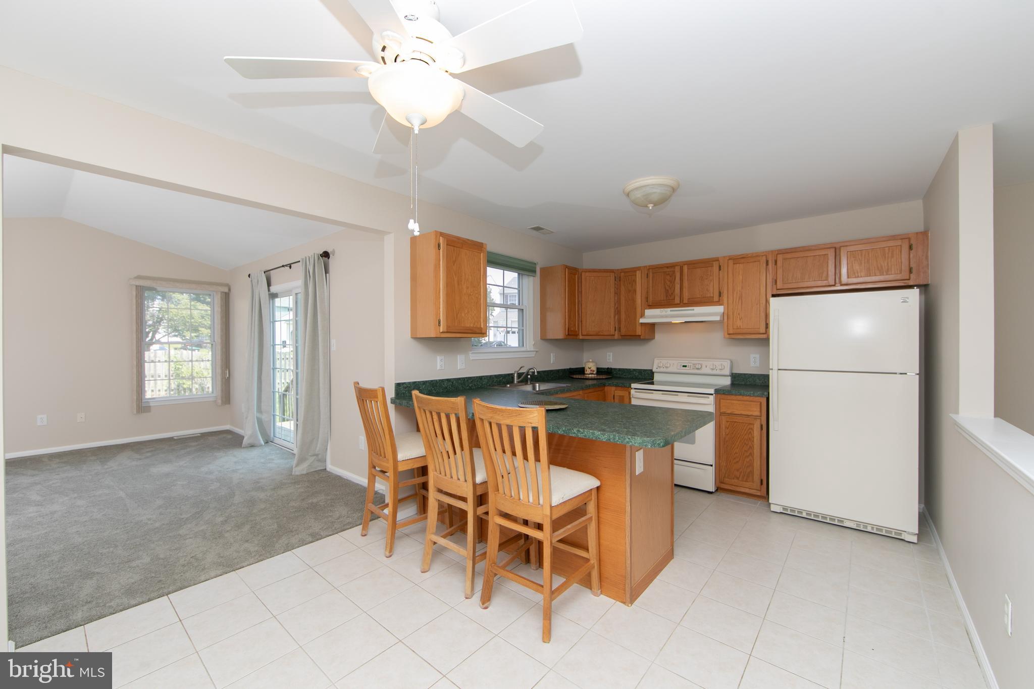 37 Wakefield Road Atco, NJ 08004 - Photo 16 of 39 a kitchen with refrigerator a stove a sink and chairs