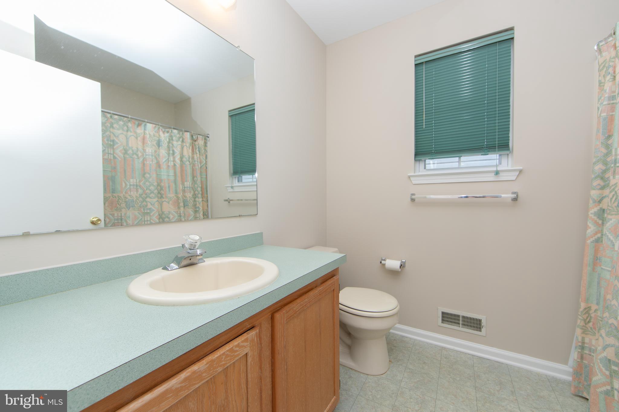37 Wakefield Road Atco, NJ 08004 - Photo 35 of 39 a bathroom with a toilet sink and mirror