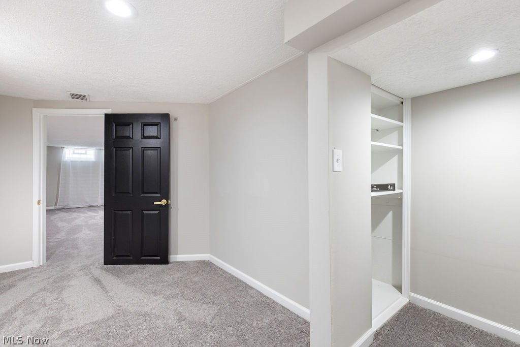 9620 David Road Garfield Heights, OH 44125 - Photo 31 of 36 Carpeted spare room with a textured ceiling