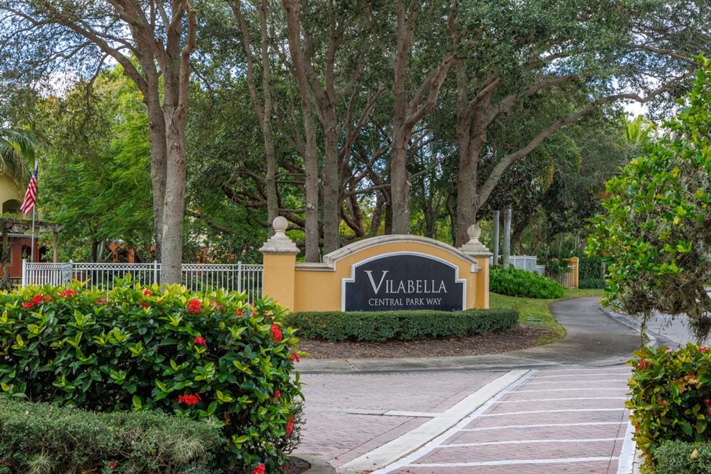 a sign that is sitting in front of flowers