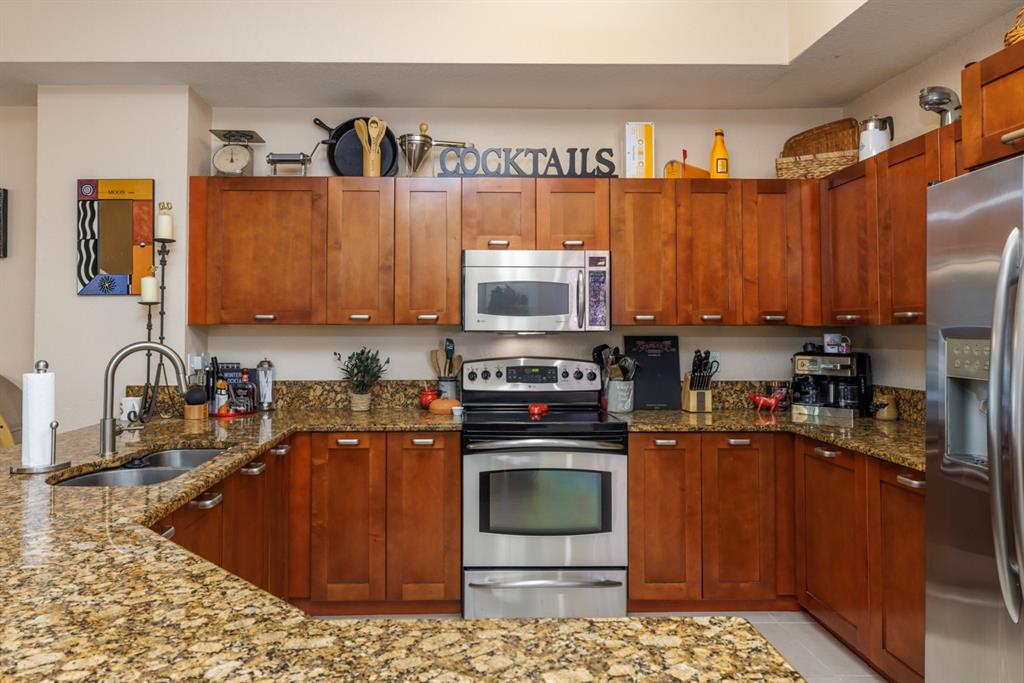 55 Southeast Palermo, Unit 105 Stuart, FL 34994 - Photo 12 of 40 a kitchen with stainless steel appliances granite countertop a stove a sink and a microwave