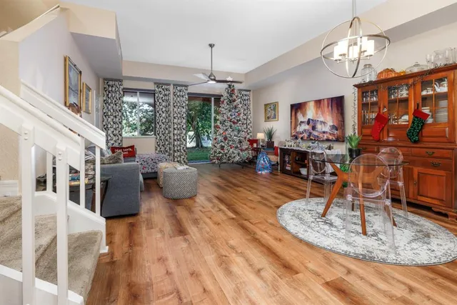 a living room with furniture a chandelier and a flat screen tv