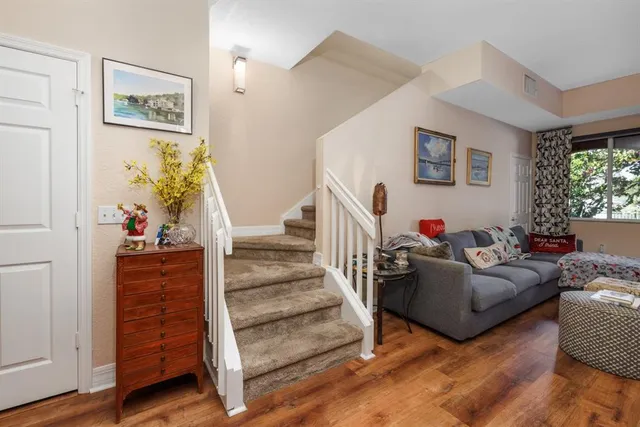 a living room with furniture and a stairs