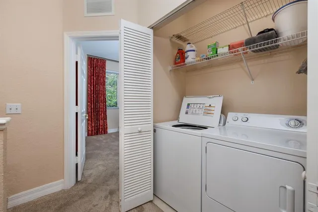 a view of storage and utility room with washer and dryer