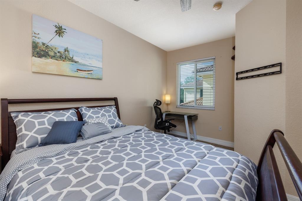 55 Southeast Palermo, Unit 105 Stuart, FL 34994 - Photo 24 of 40 a bedroom with a large bed and a window