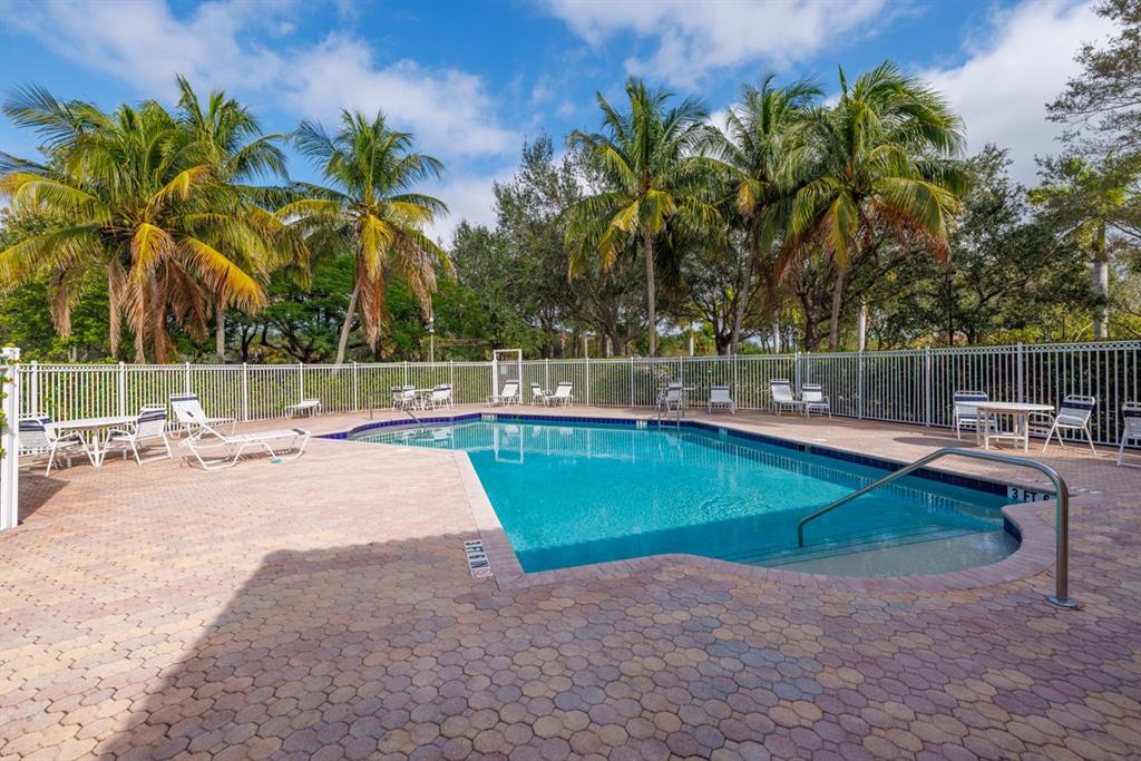 55 Southeast Palermo, Unit 105 Stuart, FL 34994 - Photo 33 of 40 a view of a swimming pool with a patio and a garden