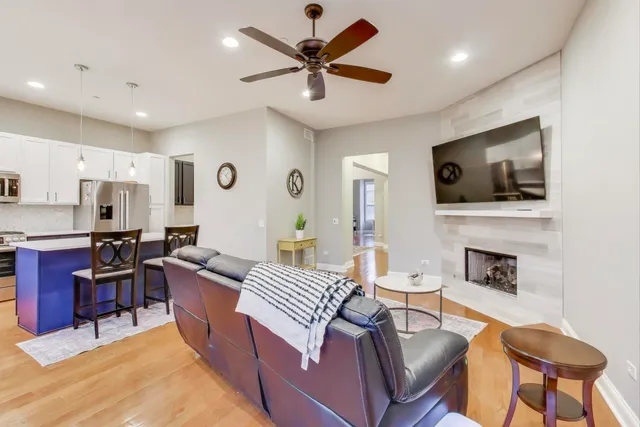 a living room with furniture a fireplace and a flat screen tv