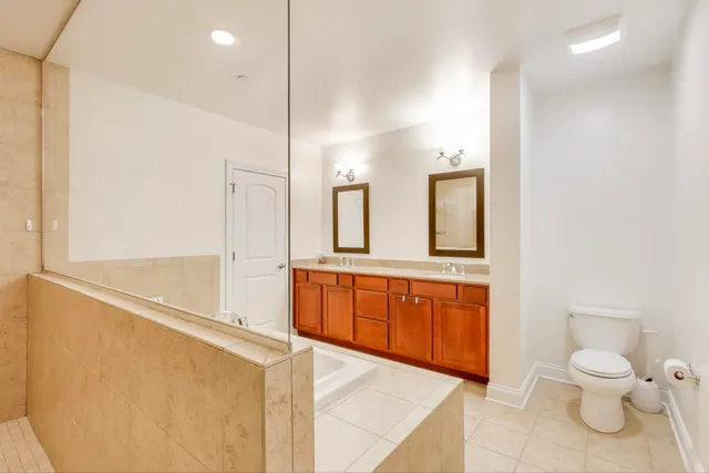 a spacious bathroom with a granite countertop sink and a mirror