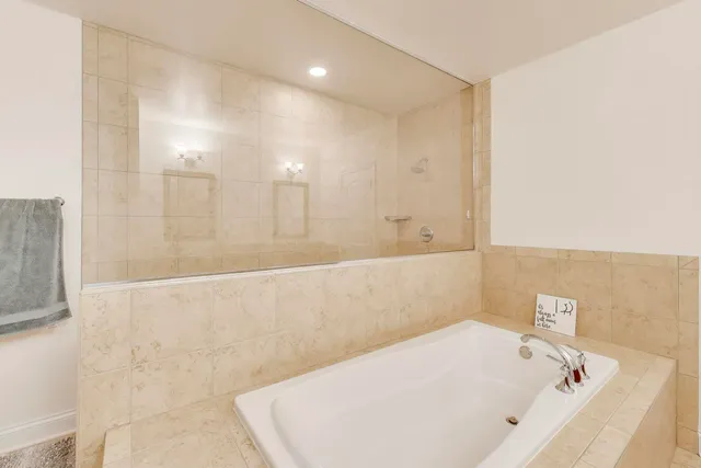 a bathroom with a bathtub and shower