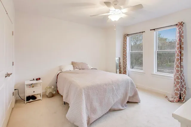 a spacious bedroom with a bed and a window