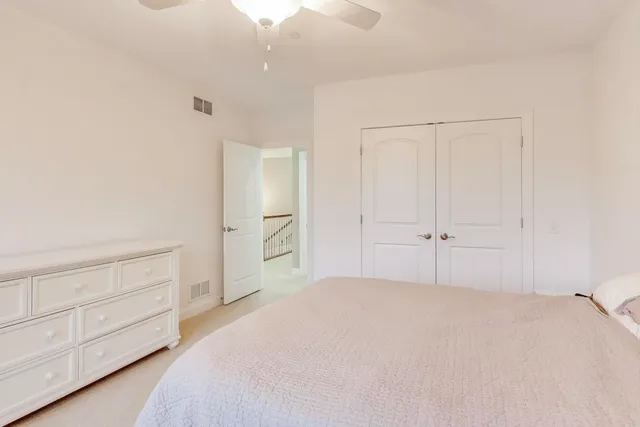 a bedroom with a bed and cabinets