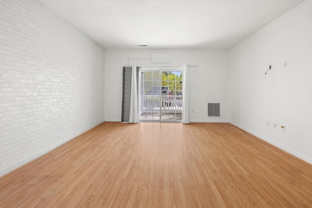 21 Hampshire Road, Unit 101 Methuen, MA 01844 - Photo 9 of 18 wooden floor in an empty room with a window