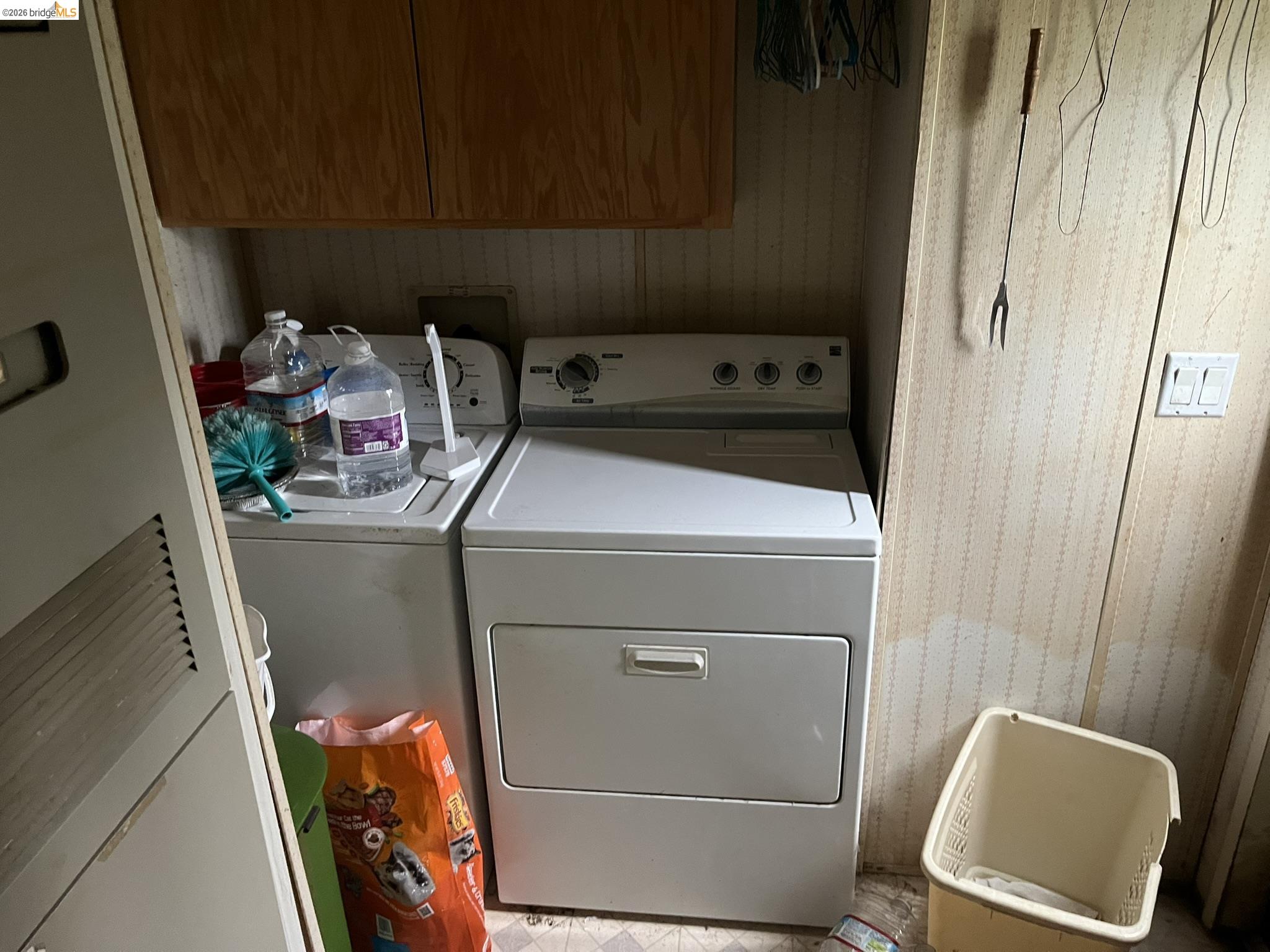 19644 Rawhide Road Sonora, CA 95370 - Photo 16 of 45 Laundry room featuring a heating unit, separate washer and dryer, and cabinet space