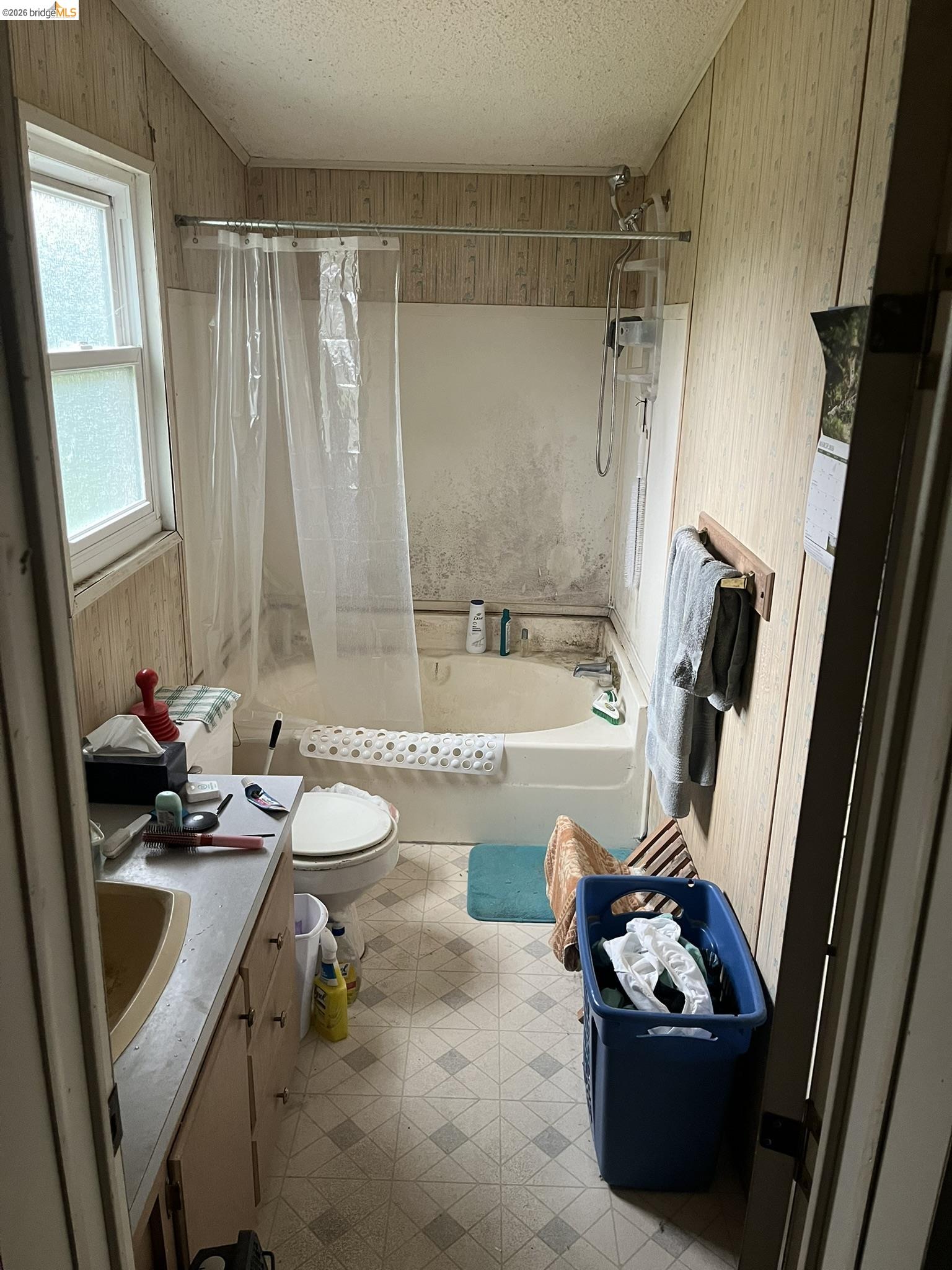19644 Rawhide Road Sonora, CA 95370 - Photo 21 of 45 Bathroom featuring vanity, tiled shower / bath combo, and a textured ceiling