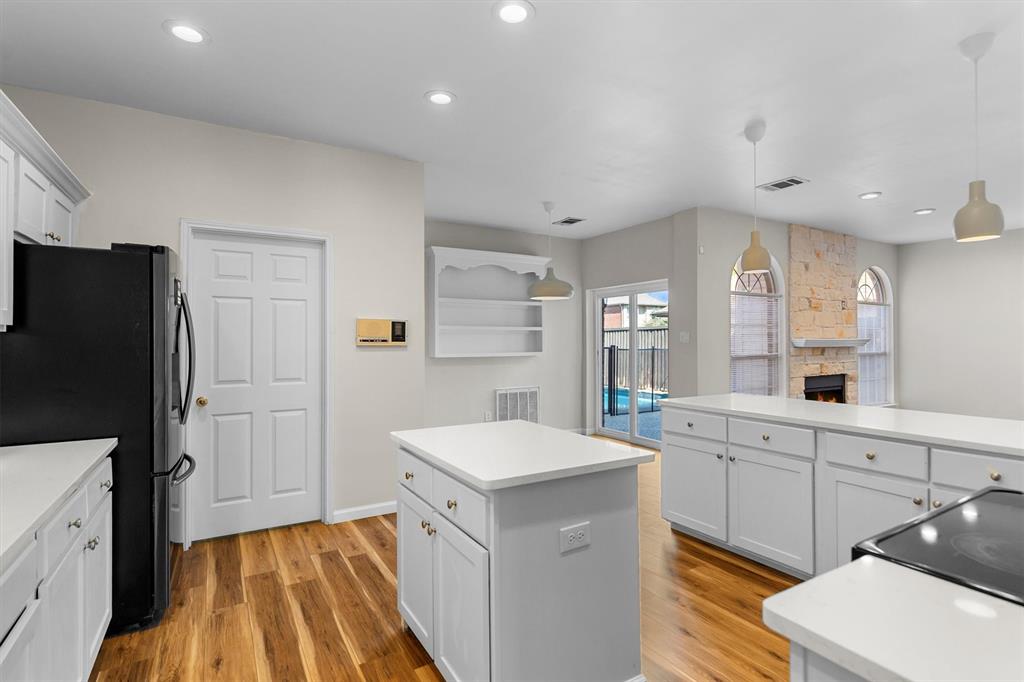 1719 Live Oak Lane Allen, TX 75002 - Photo 19 of 38 a large white kitchen with a sink a refrigerator and a stove