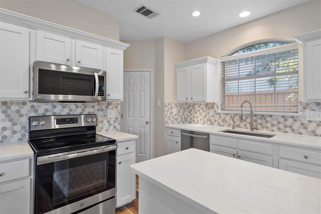 1719 Live Oak Lane Allen, TX 75002 - Photo 20 of 38 a kitchen with a stove and a microwave