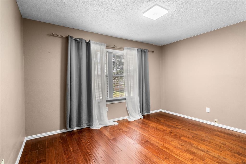 1719 Live Oak Lane Allen, TX 75002 - Photo 35 of 38 a bedroom with a bed and a window