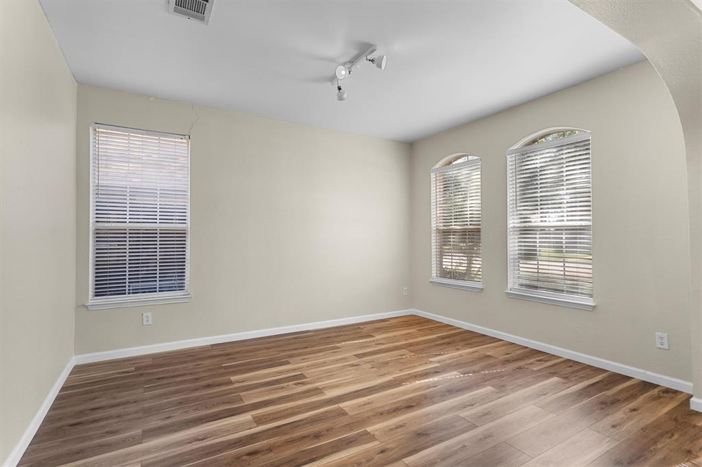 1719 Live Oak Lane Allen, TX 75002 - Photo 6 of 38 a view of an empty room with wooden floor and a window