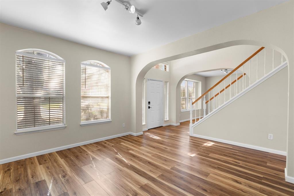 1719 Live Oak Lane Allen, TX 75002 - Photo 7 of 38 a view of an empty room with wooden floor and a window