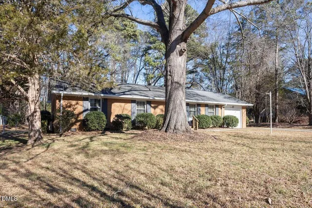 a view of a house with a yard covered in snow