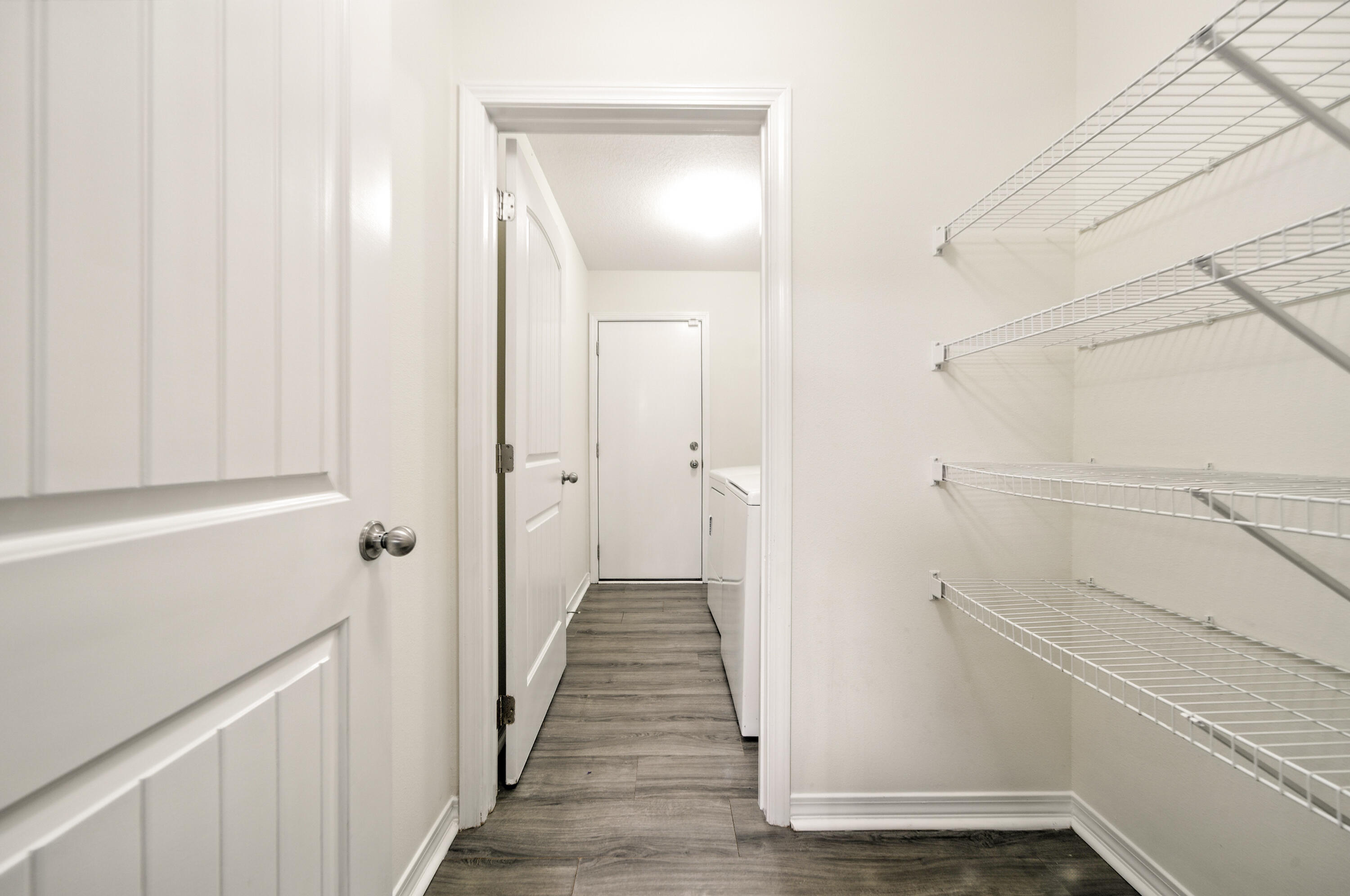 9207 Timber Lane Navarre, FL 32566 - Photo 11 of 24 a view of a hallway with wooden floor and staircase