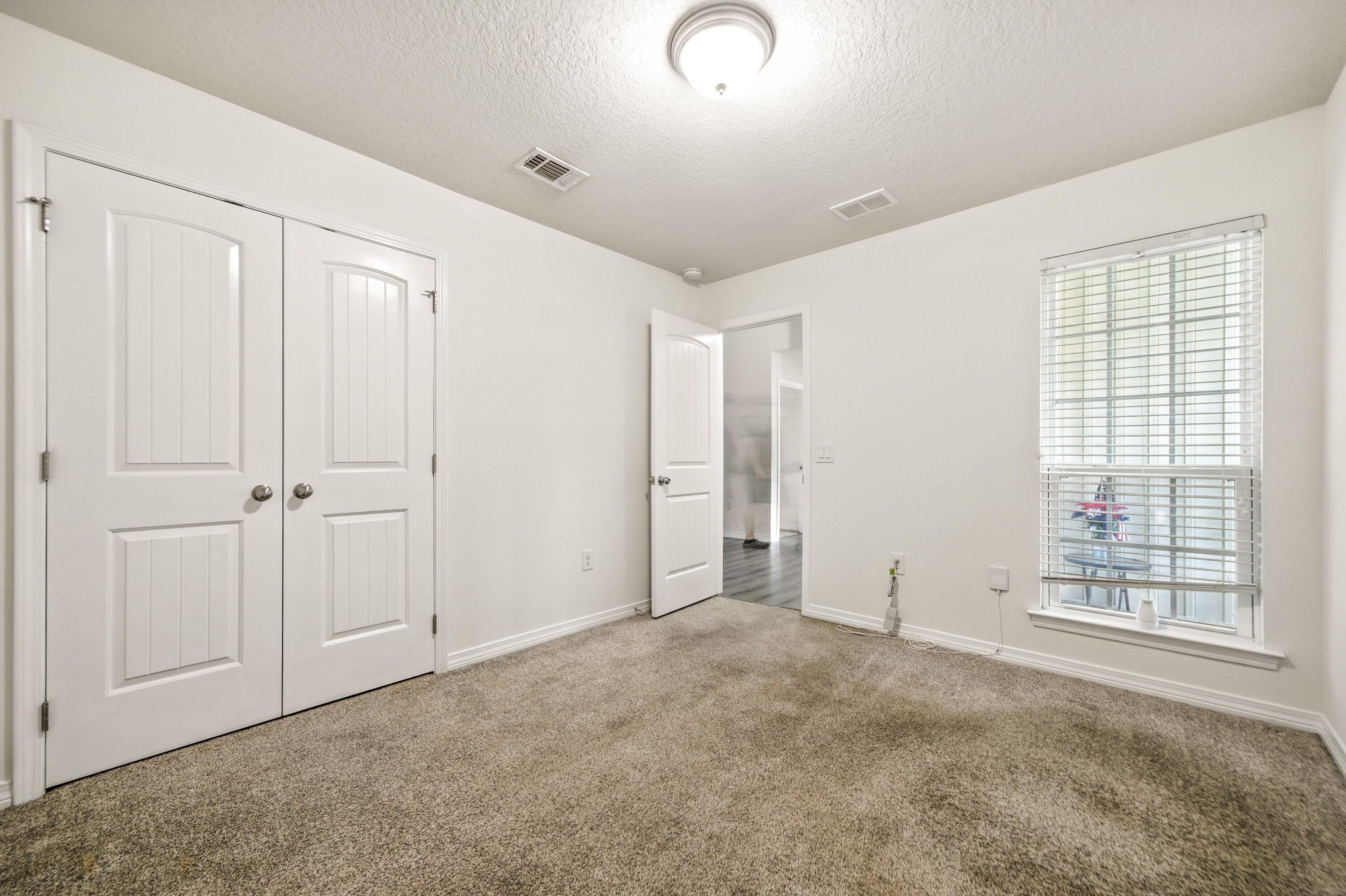 9207 Timber Lane Navarre, FL 32566 - Photo 17 of 24 a view of an empty room with a window
