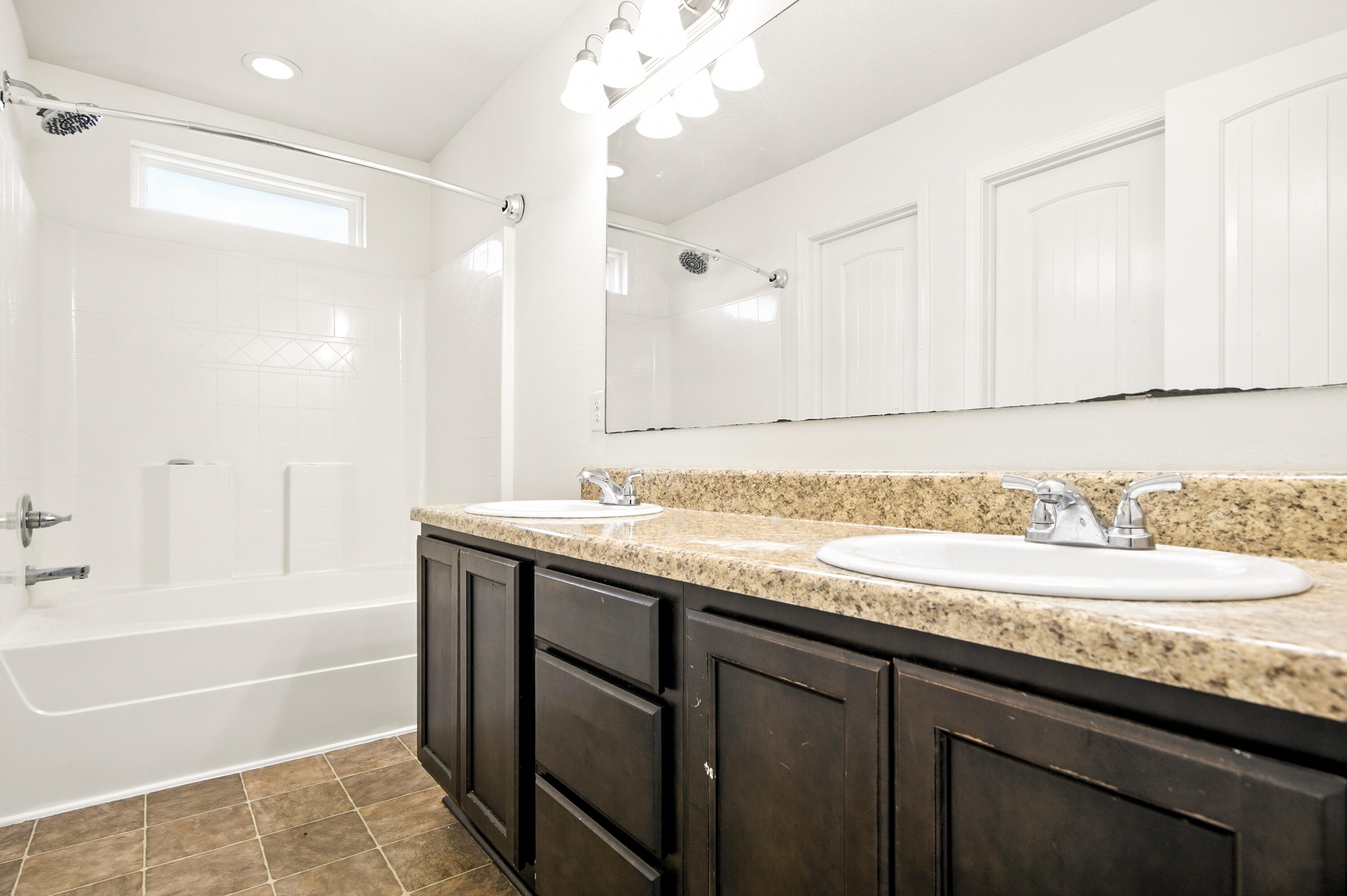 9207 Timber Lane Navarre, FL 32566 - Photo 20 of 24 a bathroom with a granite countertop sink a large mirror and a bathtub