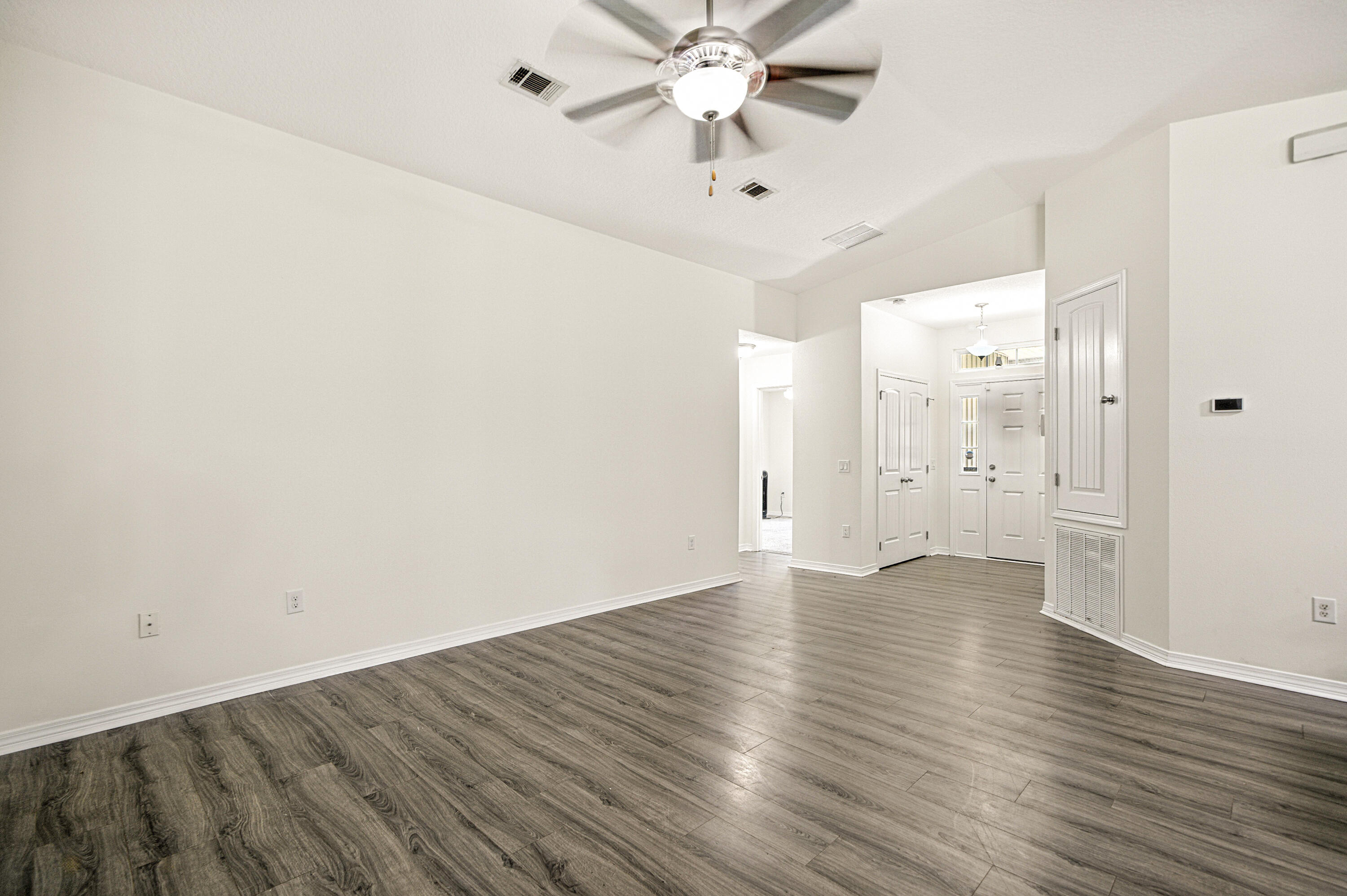 9207 Timber Lane Navarre, FL 32566 - Photo 2 of 24 a view of an empty room and wooden floor