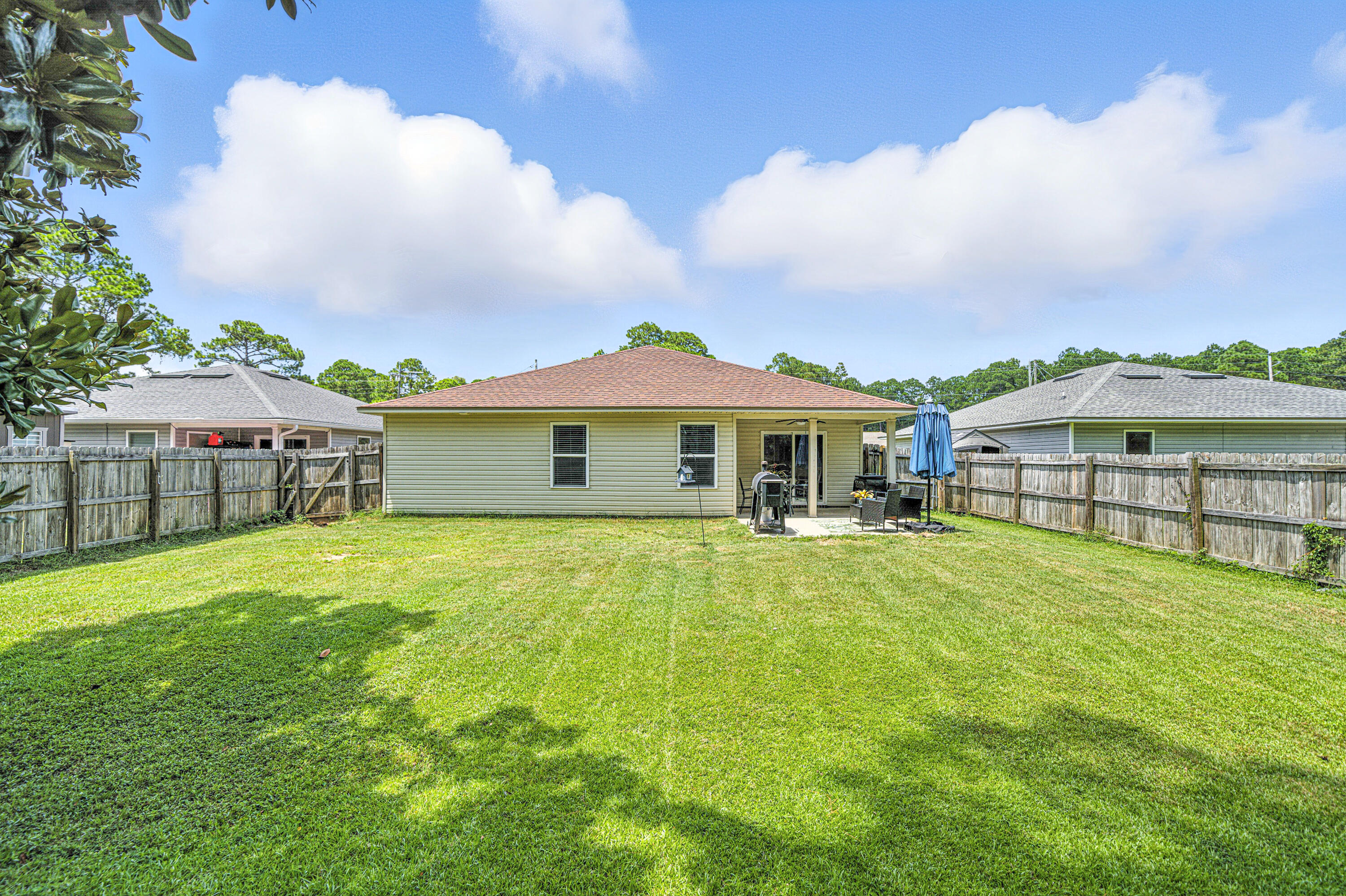 9207 Timber Lane Navarre, FL 32566 - Photo 22 of 24 a front view of a house with yard and porch