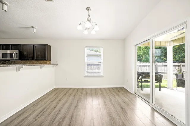 a view of a room with wooden floor and windows