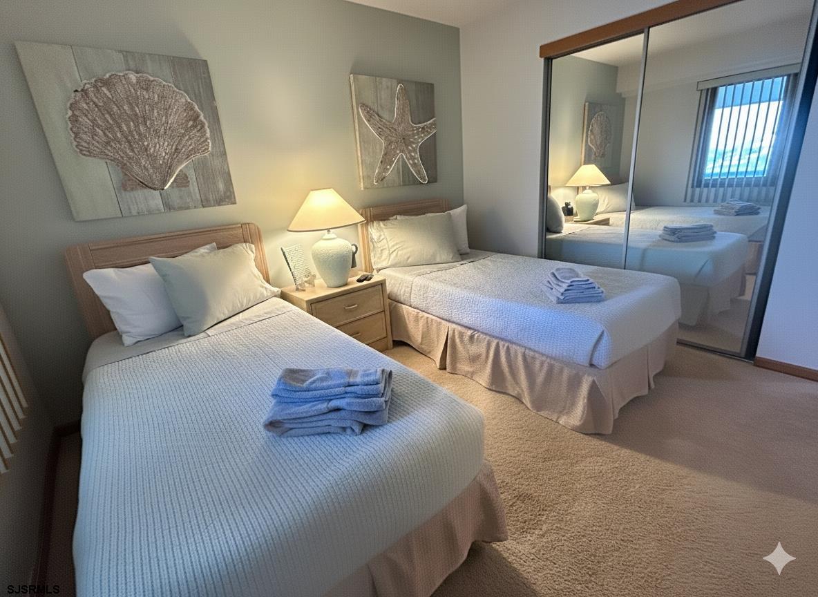 a bedroom with two beds and painting on the wall