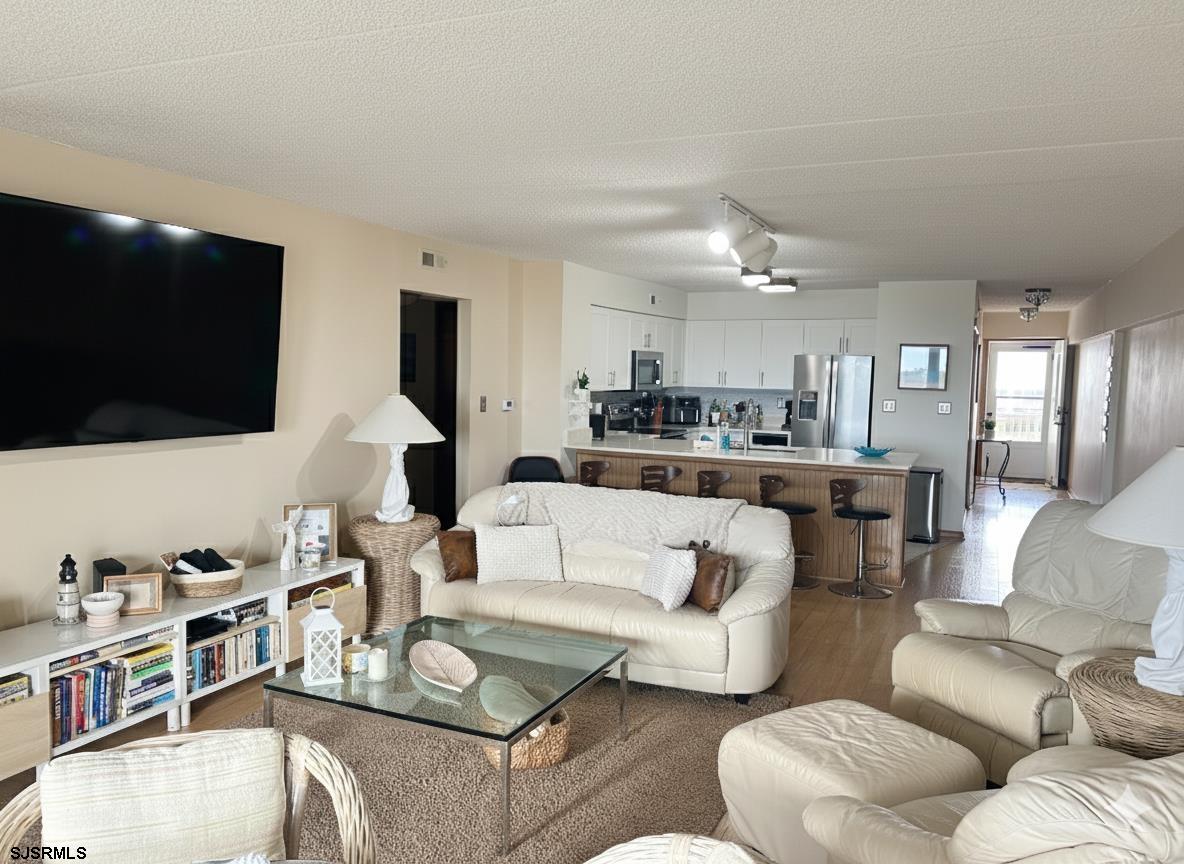 400 West Brigantine Avenue, Unit 2 Brigantine, NJ 08203 - Photo 11 of 24 a living room with furniture and a flat screen tv