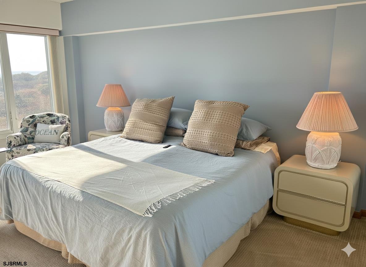 400 West Brigantine Avenue, Unit 2 Brigantine, NJ 08203 - Photo 11 of 24 a bedroom with a bed and a chair
