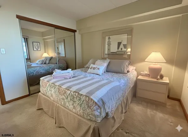 a bedroom with a bed and a mirror