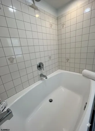a bathroom with a granite countertop double vanity sink and a mirror