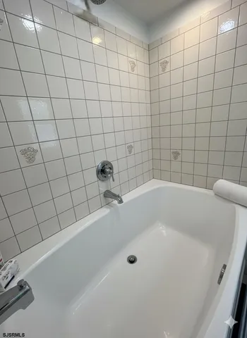 a bathroom with a granite countertop double vanity sink and a mirror