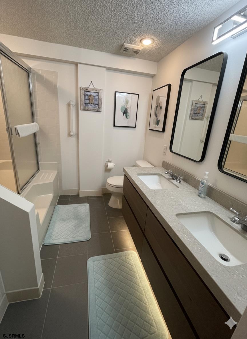 400 West Brigantine Avenue, Unit 2 Brigantine, NJ 08203 - Photo 20 of 24 a bathroom with a granite countertop double vanity sink and a mirror