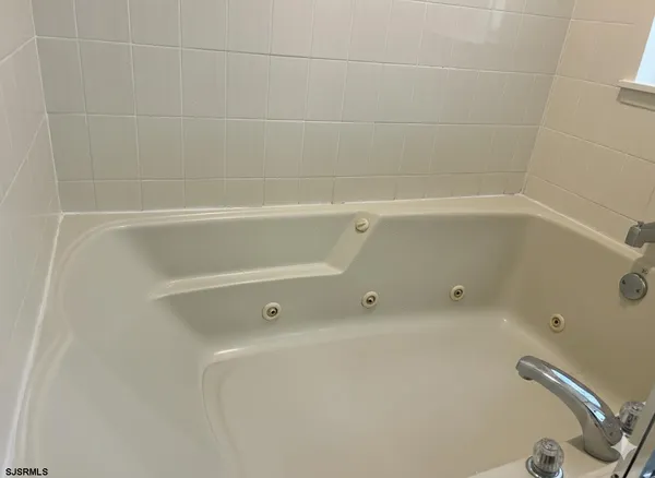 a bedroom with bed and a lamp