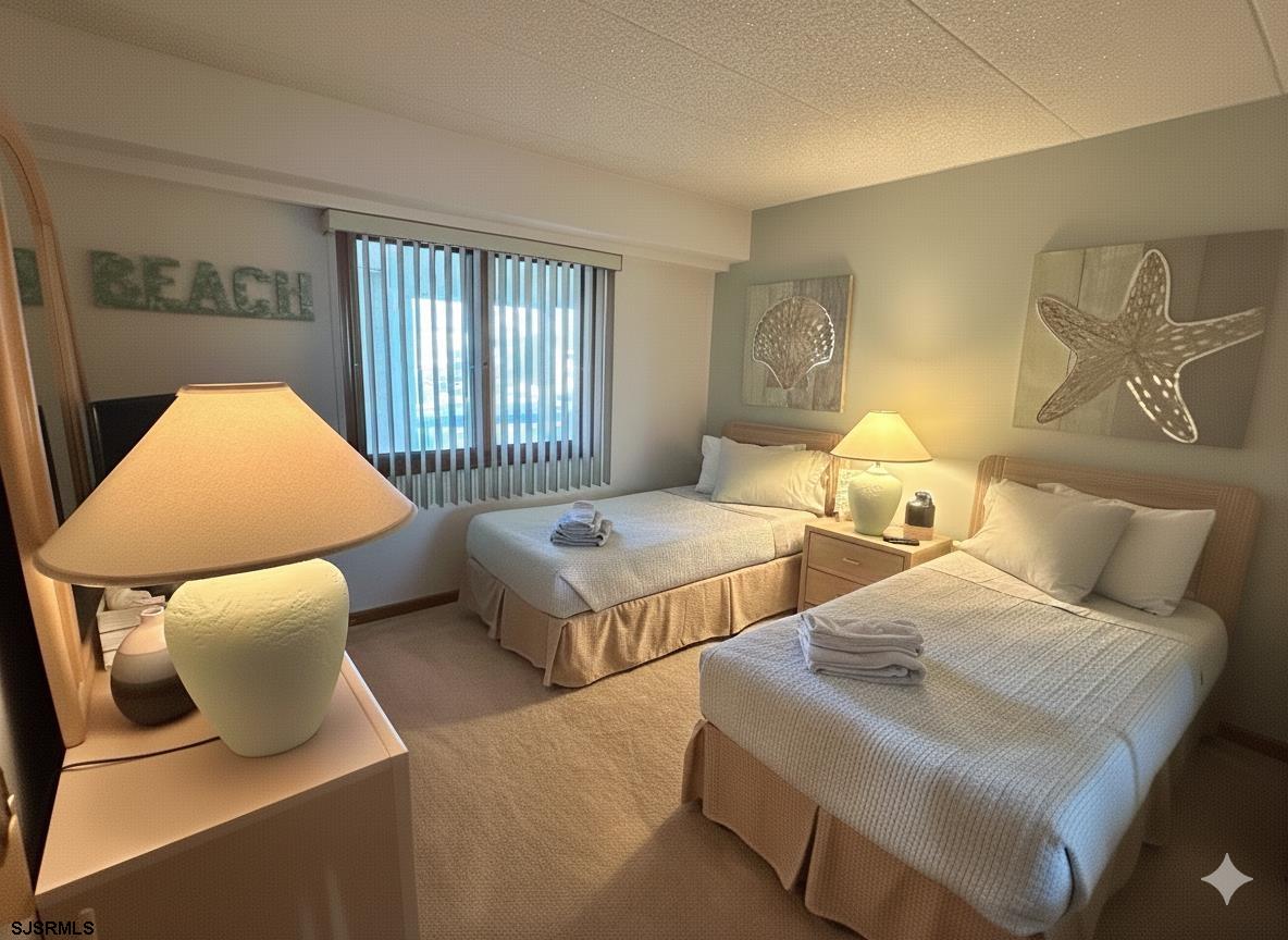 400 West Brigantine Avenue, Unit 2 Brigantine, NJ 08203 - Photo 5 of 24 a bedroom with two beds and lamp