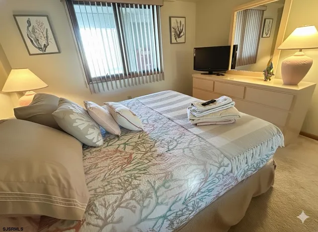 a bedroom with a bed and flat screen tv