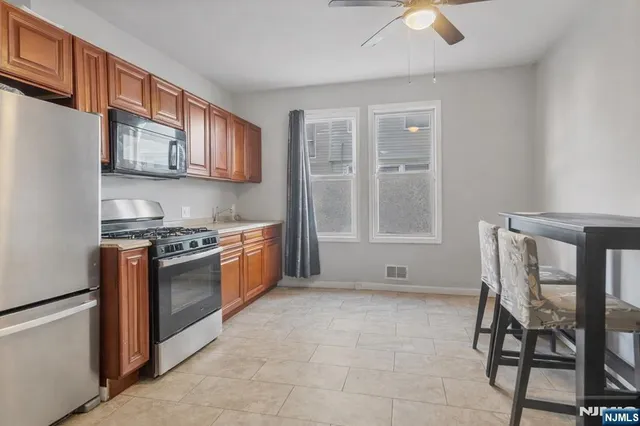 a kitchen with stainless steel appliances granite countertop a stove and a microwave
