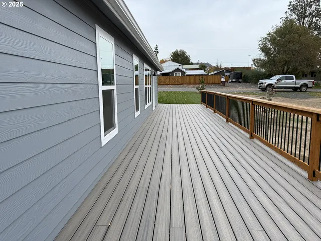 a view of a balcony with wooden floor