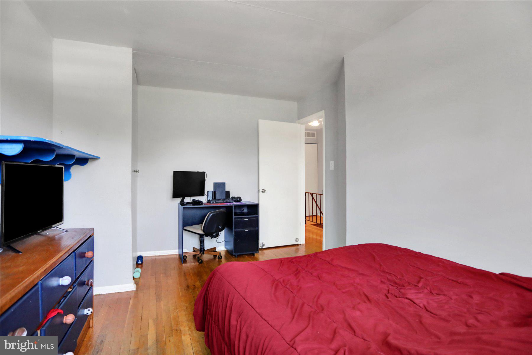 959 Elm Road Baltimore, MD 21227 - Photo 12 of 27 a bedroom with a bed and a flat screen tv