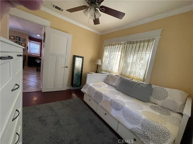 a spacious bedroom with a bed and a chandelier