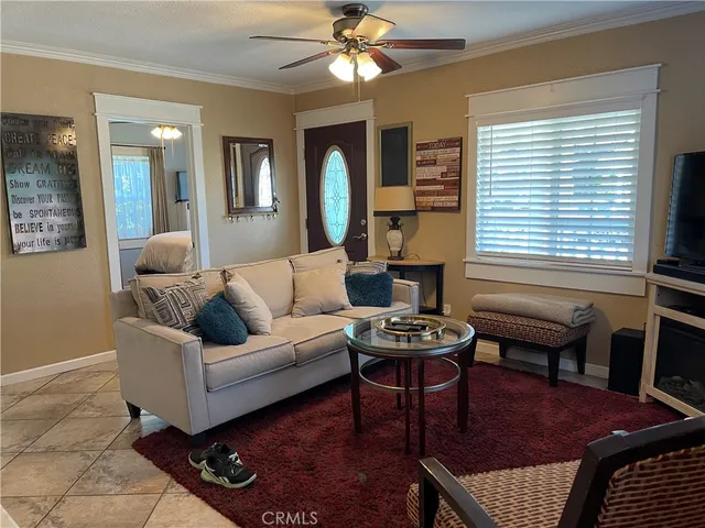 a living room with furniture a fireplace and a window