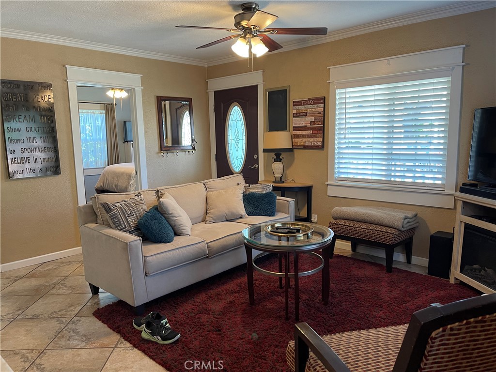 113 East 11th Street Redlands, CA 92374 - Photo 3 of 18 a living room with furniture a fireplace and a window