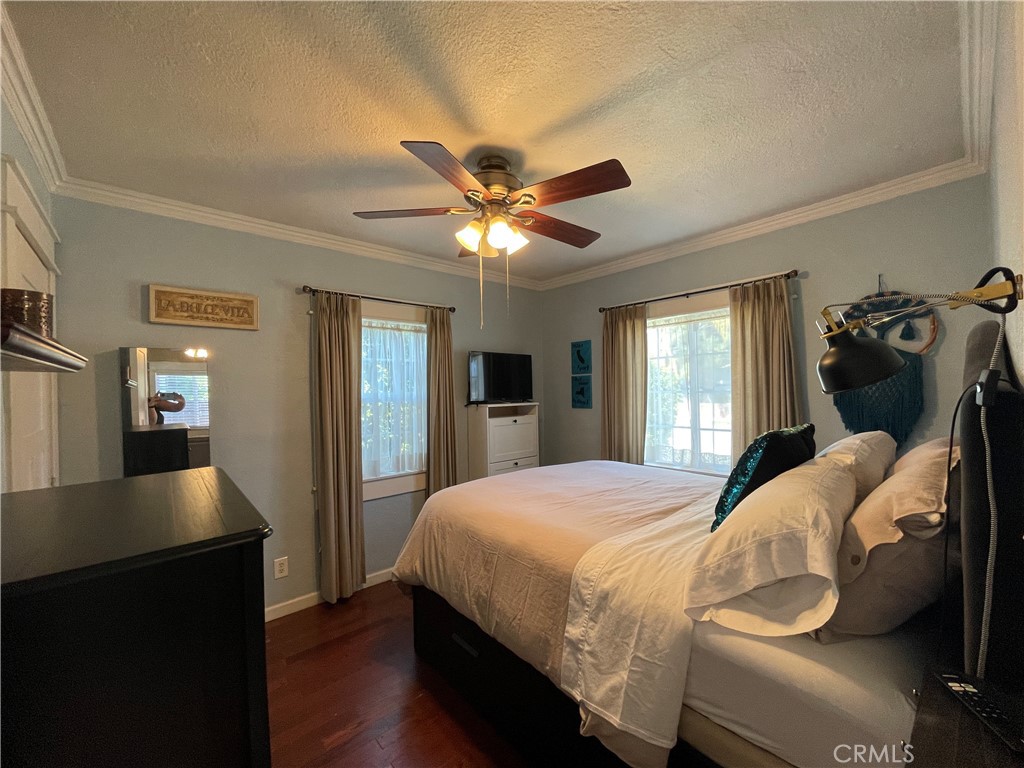 113 East 11th Street Redlands, CA 92374 - Photo 8 of 18 a bedroom with a bed and a chandelier