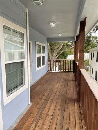 a view of outdoor space with wooden floor and balcony