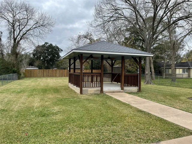 a view of a house with yard and sitting area